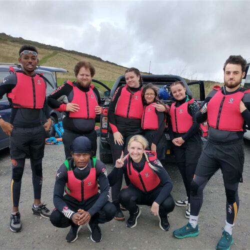 People standing in a group with vests on